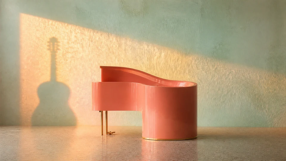Havana Harmony artwork: a sculptural coral piano against a seafoam wall, crossed by a large guitar shadow and golden morning light.