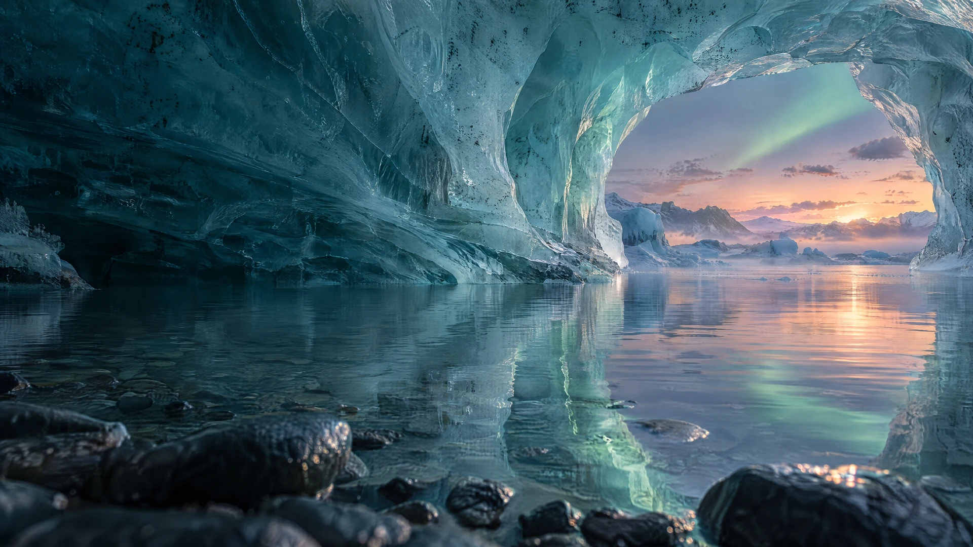 Translucent aquamarine ice opens onto a still lagoon and a rose-lit horizon beneath a delicate aurora.